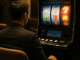 An adult player considers the changing rhythm of a slot machine session in a